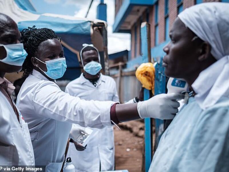 Staff of a NGO measuring a patient's body temperature in Nairobi, Kenya, to check for coronavirus yesterday (file image/AFP)