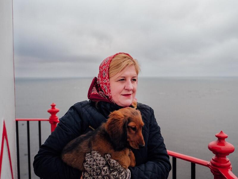 Elly Karjam, who is in charge of the lighthouse of the island, poses on November 20, 2019 on Kihnu island in the Baltic Sea, 10 kilometres (six miles) off the coast of Estonia. Steeped in folk traditions, Kihnu's historic way of life however is now threatened as economic hardship drives more and more islanders away in search of work. Alessandro RAMPAZZO / AFP