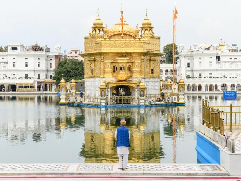 A Sikh devotee pays respect at the deserted Golden Temple during the first day of a 21-day government-imposed nationwide lockdown as a preventive measure against the COVID-19 coronavirus, in Amritsar on March 25, 2020. NARINDER NANU / AFP