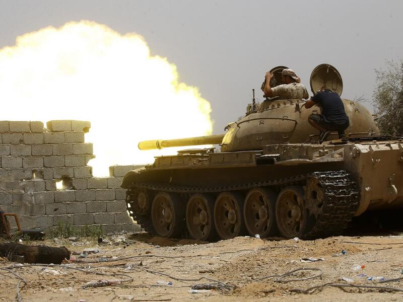 In this file photo taken on June 13, 2019, fighters loyal to the UN-recognised Government of National Accord (GNA) open tank fire from their position in the al-Sawani area south of the Libyan capital Tripoli during clashes with forces loyal to strongman Khalifa Haftar. AFP