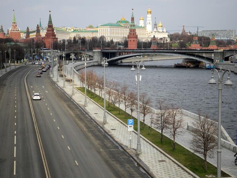 A bicyclist rides on the empty embankment close to the Kremlin in central Moscow on April 3, 2020, amid the spread of the COVID-19, the novel coronavirus. Kirill KUDRYAVTSEV / AFP