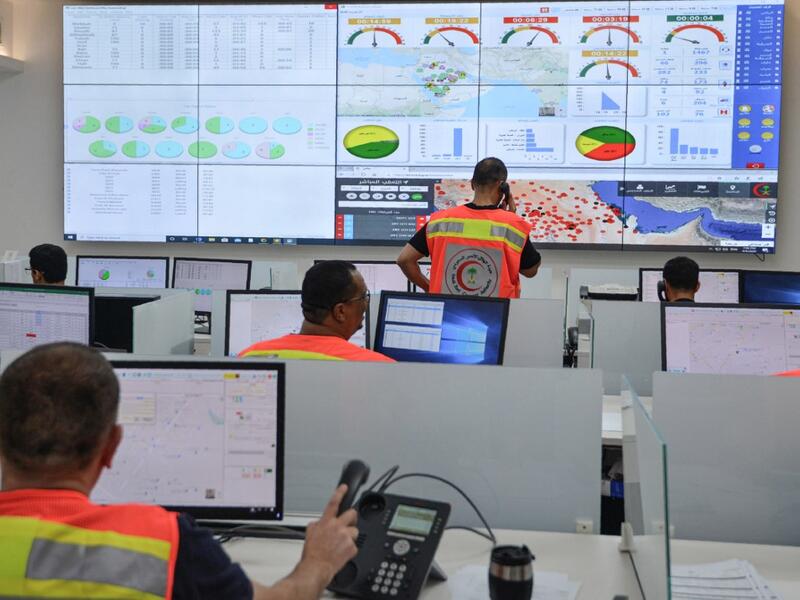 Employees of the COVID-19 coronavirus disease operations room of the Saudi Red Crescent (SRC) are seen while on duty in the Saudi capital Riyadh, on April 6, 2020. The SRC increased their employees to meet the increased demand on ambulances since the novel coronavirus appeared and the kingdom imposed a curfew. FAYEZ NURELDINE / AFP