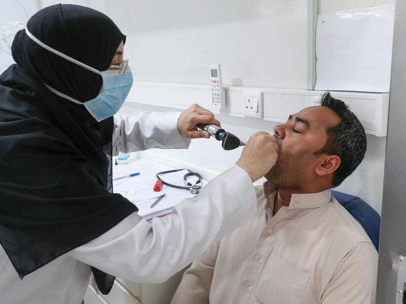 A Saudi nurse checks a patient at a mobile clinic catering for the residents of Ajyad Almasafi district in the holy city of Mecca, on April 7, 2020, which authorities have sealed-off, along with other major cities, amid measures to curb the spread of COVID-19. AFP/File