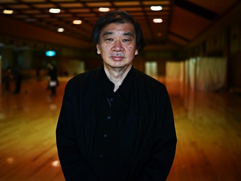 This photo taken on April 14, 2020 shows Japanese architect Shigeru Ban posing for a photo at the shelter he and his team devised which hosts people who can’t afford to rent an apartment and used to stay at designated internet cafes, now closed due to the COVID-19 coronavirus outbreak state of emergency, at a judo sport hall in Yokohama, Kanagawa prefecture.CHARLY TRIBALLEAU / AFP