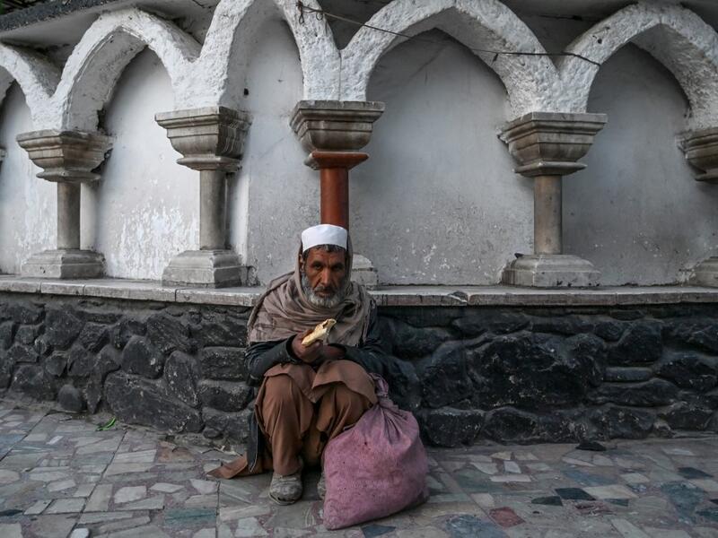 A Muslim man sits as he breaks his first fast day during the Muslim holy month of Ramadan outside a mosque in Kabul on April 24, 2020. The Taliban have dismissed a government call for a Ramadan ceasefire in Afghanistan, saying a truce is "not rational" as they ramp up attacks on government forces. WAKIL KOHSAR / AFP