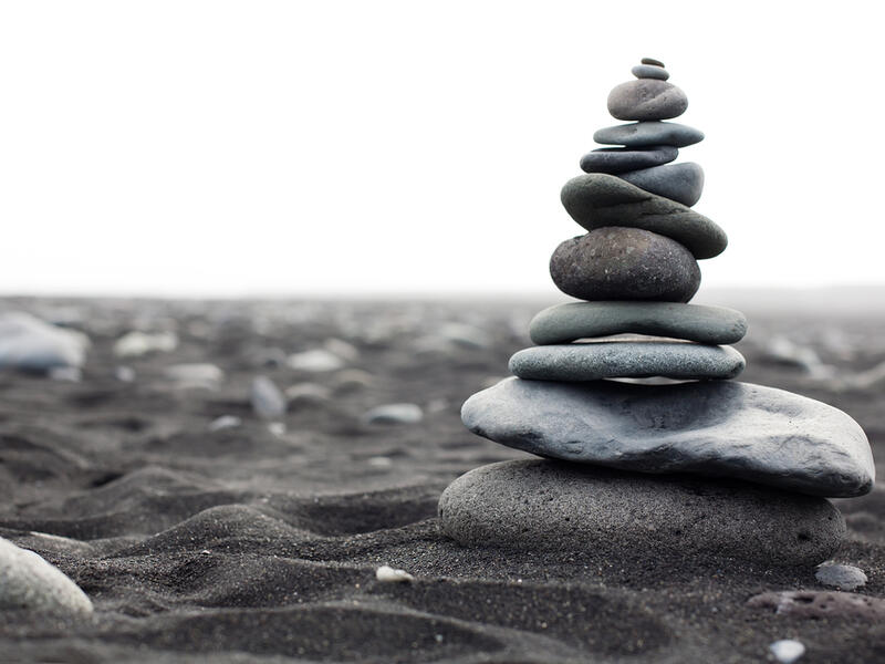 Pyramid from stones on the black sand beach in Iceland. The image close up  (Shutterstock)