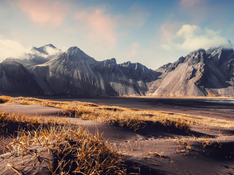 Vestrahorn mountaine on Stokksnes cape in Iceland during sunset. Amazing Iceland nature seascape. popular tourist attraction. Best famouse travel locations. Scenic Image of Iceland (Shutterstock)