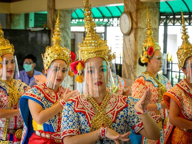 Traditional Thai dancers wearing protective face shields perform at the Erawan Shrine, which was reopened after the Thai government relaxed measures to combat the spread of the COVID-19 novel coronavirus, in Bangkok on May 4, 2020. Thailand began easing restrictions related to the COVID-19 novel coronavirus on May 3 by allowing various businesses to reopen, but warned that the stricter measures would be re-imposed should cases increase again. Mladen ANTONOV / AFP