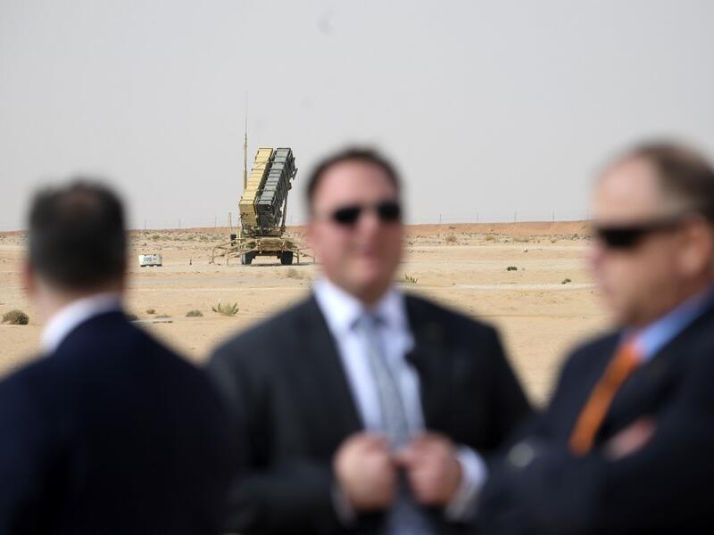 n this file photo taken on February 20, 2020 Security for US Secretary of State Mike Pompeo (L) is pictured near a Patriot missile battery as he visits the Prince Sultan air base in Al-Kharj, in central Saudi Arabia. The US is pulling out four of its powerful Patriot missile systems from Saudi Arabia, after determining the threat from Iran that sparked an arms buildup in the region last year had waned, a Defense Department official said May 7, 2020. ANDREW CABALLERO-REYNOLDS / AFP