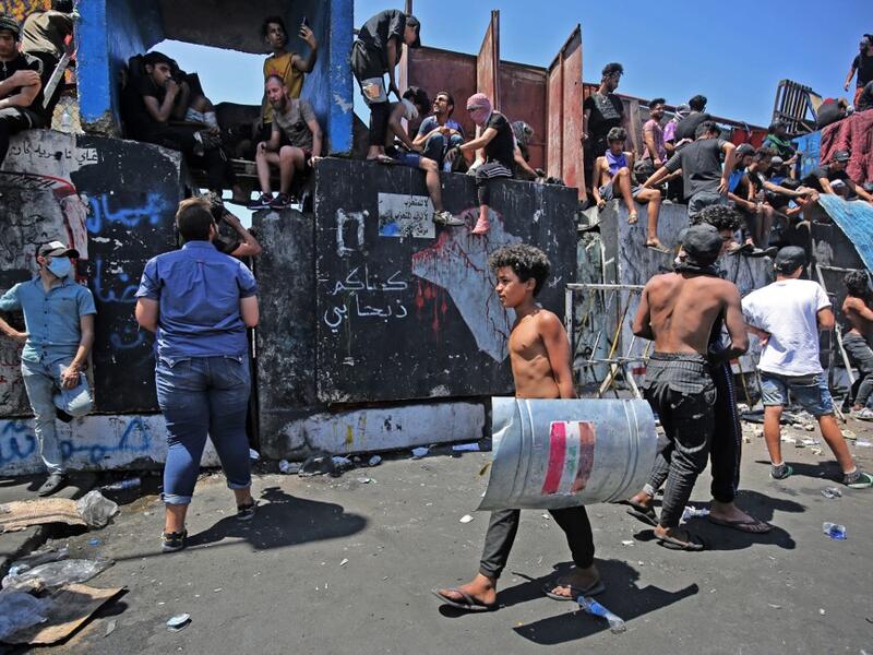 Iraqi protesters gather on the Al-Jumhuriyah bridge in the capital Baghdad on May 11, 2020, during an anti-government demonstration. Modest anti-government rallies resumed in some Iraqi cities Sunday, clashing with security forces and ending months of relative calm just days after Prime Minister Mustafa Kadhemi's government came to power. AHMAD AL-RUBAYE / AFP