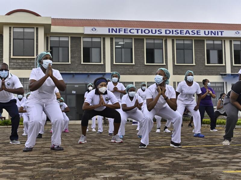 Nurses assigned to the Infectious Diseases Unit (IDU) at the Kenyatta University Hospital dance during a Zumba class held at the hospital compound in Nairobi, on May 17, 2020. Coinciding with the morning shift rotation the class, aimed to offer some respite to nurses charged with the management of patients infected with COVID-19 coronavirus, was organised by the Nursing Council of Kenya (NCK) and the Kenyatta Univesity Teaching, Refferal and Research Hospital in the Kenyan capital. TONY KARUMBA / AFP