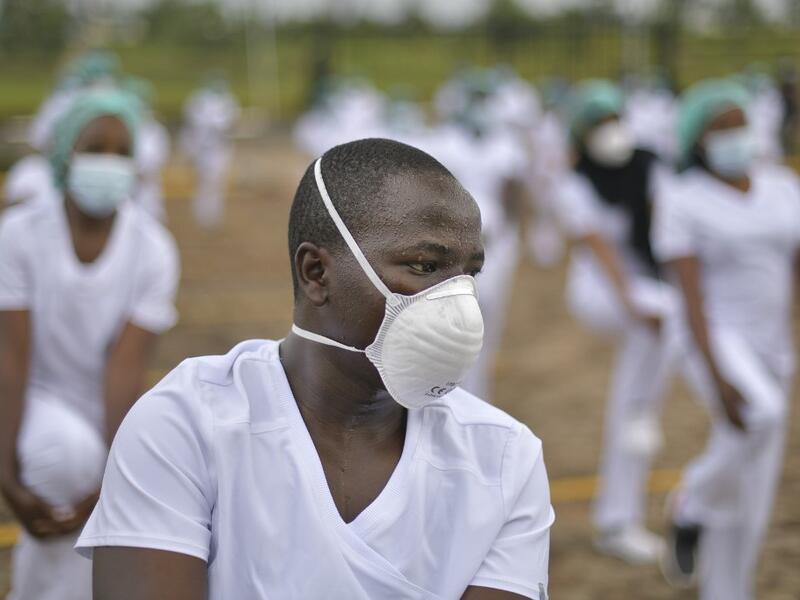 Nurses assigned to the Infectious Diseases Unit (IDU) at the Kenyatta University Hospital is seen dancing during a Zumba class held at the hospital compound in Nairobi, on May 17, 2020. Coinciding with the morning shift rotation the class, aimed to offer some respite to nurses charged with the management of patients infected with COVID-19 coronavirus, was organised by the Nursing Council of Kenya (NCK) and the Kenyatta Univesity Teaching, Refferal and Research Hospital in the Kenyan capital. TONY KARUMBA / 