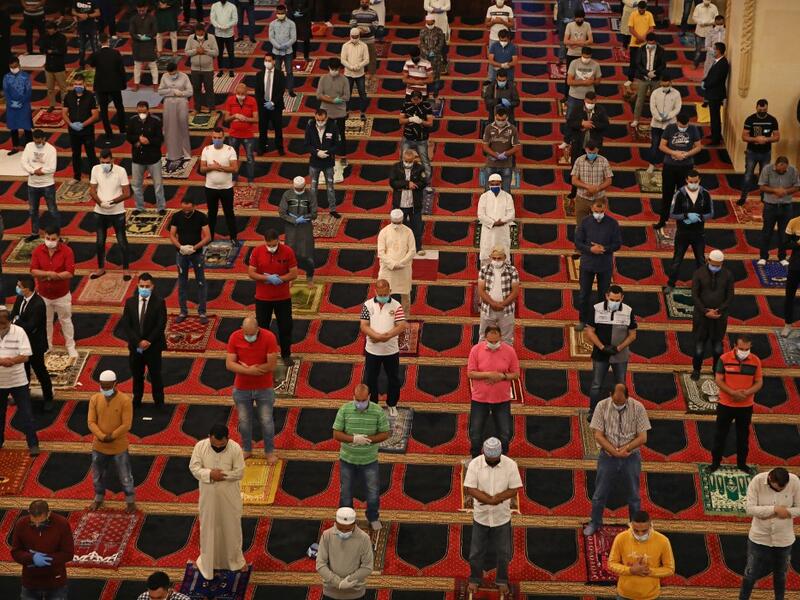 Muslim worshippers take part in a morning prayer to celebrate the Eid al-Fitr holiday while wearing protective masks and maintaining social distancing due to the COVID-19 pandemic, at Mohammed al-Amin Mosque in the Lebanese capital Beirut's downtown district on May 24, 2020. ANWAR AMRO / AFP
