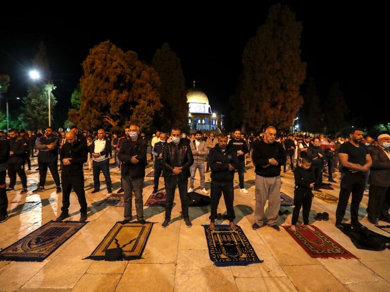 Palestinians perform the dawn prayer (salat al-fajr) inside the al-Aqsa mosque compound, in Jerusalem's Old City on May 31, 2020, after a two-month closure due to the COVID-19 pandemic. AHMAD GHARABLI / AFP