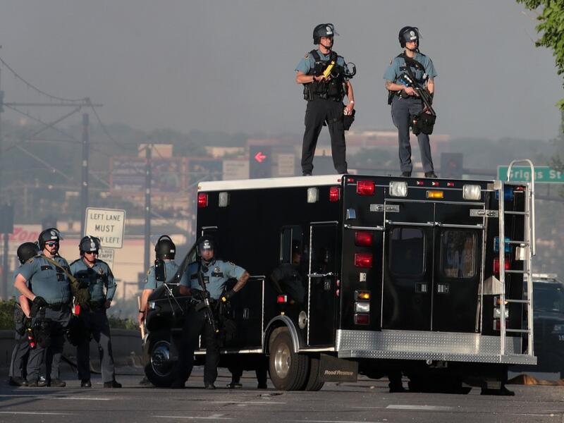Police stand watch near a protest May 28, 2020 in St. Paul, Minnesota. Today marks the third day of ongoing protests after the police killing of George Floyd. Four Minneapolis police officers have been fired after a video taken by a bystander was posted on social media showing Floyd's neck being pinned to the ground by an officer as he repeatedly said, "I cant breathe." SCOTT OLSON / GETTY IMAGES NORTH AMERICA / Getty Images via AFP