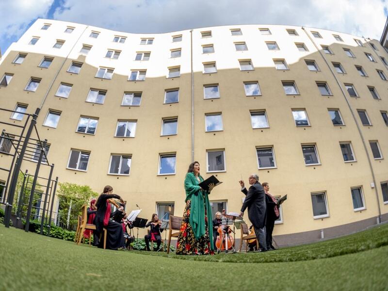 Guests of Zeitgeist Hotel listen from their rooms to singers Monika Medek and Dagmar Dekanovsky and the Camerata Carnutum orchestra, during a window concert (Fensterkonzert) in Vienna on May 30, 2020, as hotels have reopened in Austria amid the novel coronavirus pandemic. JOE KLAMAR / AFP