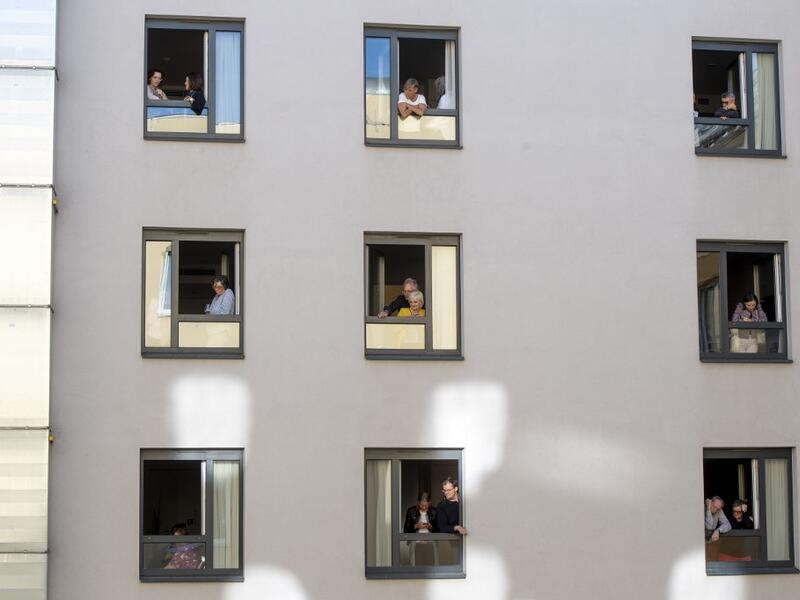 Guests of Zeitgeist Hotel listen from their rooms to singers Monika Medek and Dagmar Dekanovsky and the Camerata Carnutum orchestra, during a window concert (Fensterkonzert) in Vienna on May 30, 2020, as hotels have reopened in Austria amid the novel coronavirus pandemic. JOE KLAMAR / AFP