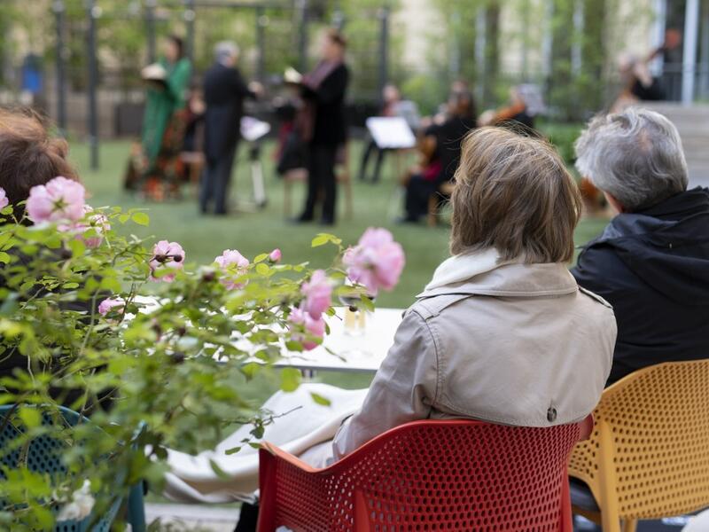 Guests of Zeitgeist Hotel listen to singers Monika Medek and Dagmar Dekanovsky and the Camerata Carnutum orchestra, during a window concert (Fensterkonzert) in Vienna on May 30, 2020, as hotels have reopened in Austria amid the novel coronavirus pandemic. JOE KLAMAR / AFP