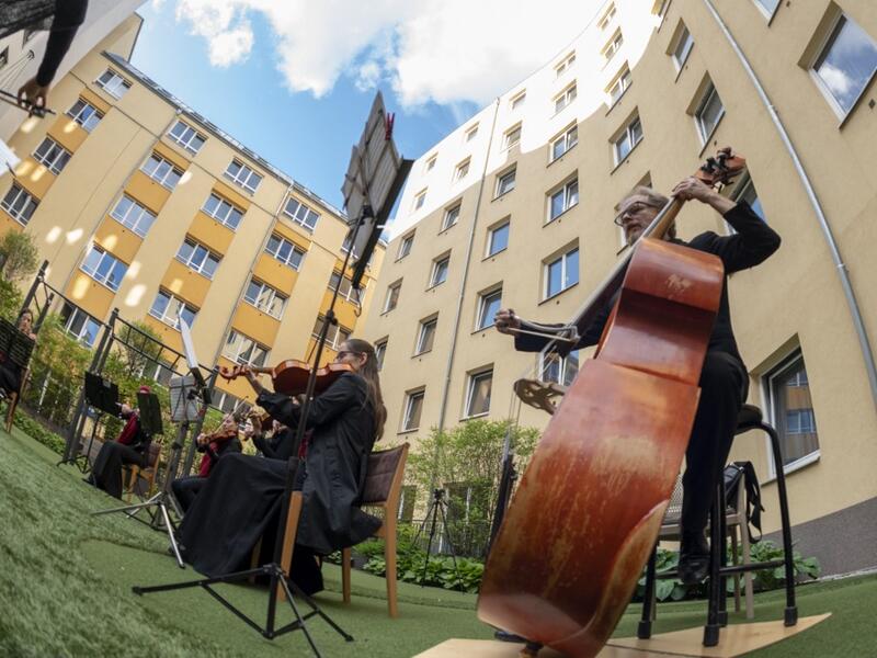 Guests of Zeitgeist Hotel listen from their rooms to singers Monika Medek and Dagmar Dekanovsky and the Camerata Carnutum orchestra, during a window concert (Fensterkonzert) in Vienna on May 30, 2020, as hotels have reopened in Austria amid the novel coronavirus pandemic. JOE KLAMAR / AFP