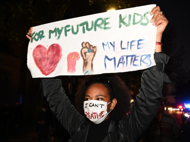 A protesters holds a banner and shout slogans during a rally for justice in Sydney on June 2, 2020, against the deaths of members of the Aboriginal community in Australia and the death of George Floyd, an unarmed black man who died in police custody in the US city of Minneapolis which has sparked violent protests across the US. PETER PARKS / AFP
