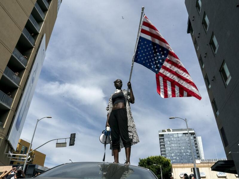 A protesters takes a moment while speaking to the crowd as they march through Hollywood during a demonstration over the death of George Floyd while in Minneapolis Police custody, in Los Angeles, California, June 2, 2020. Anti-racism protests have put several US cities under curfew to suppress rioting, following the death of George Floyd in police custody. Kyle Grillot / AFP