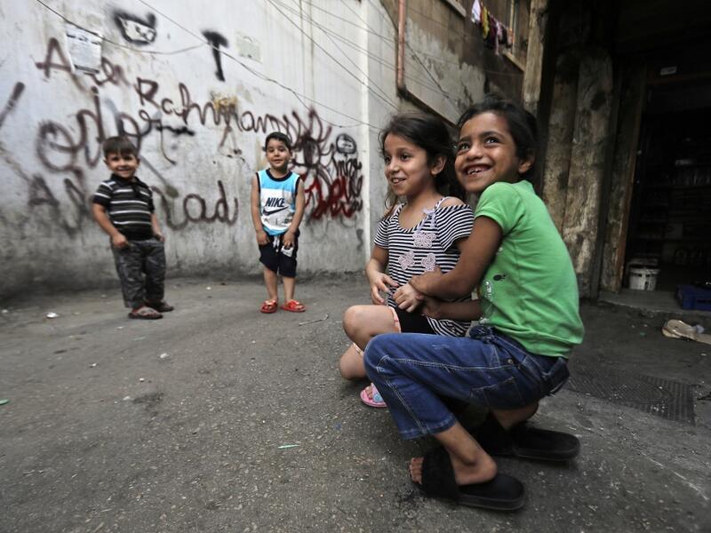 A boy looks out from a balconey along an alley in the Bab al-Tabbaneh neighbourhood of Lebanon's northern city of Tripoli on June 3, 2020. Thousands of residents of Lebanon's northern Tripoli struggle to put food on the table, as the country's worst economic crisis in decades has picked up in speed in recent weeks, with food prices rising by more than 70 percent since the autumn. Inflation has been a blow in the country where more than 45 percent of the country's population now lives below the poverty line,