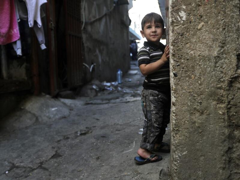 A child looks on while standing along the wall of a building along an alley in the Bab al-Tabbaneh neighbourhood of Lebanon's northern city of Tripoli on June 3, 2020. Thousands of residents of Lebanon's northern Tripoli struggle to put food on the table, as the country's worst economic crisis in decades has picked up in speed in recent weeks, with food prices rising by more than 70 percent since the autumn. Inflation has been a blow in the country where more than 45 percent of the country's population now 