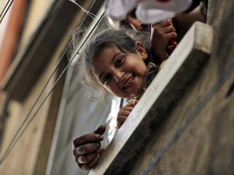 A girl peeks out of a window in the Bab al-Tabbaneh neighbourhood of Lebanon's northern city of Tripoli on June 3, 2020. Thousands of residents of Lebanon's northern Tripoli struggle to put food on the table, as the country's worst economic crisis in decades has picked up in speed in recent weeks, with food prices rising by more than 70 percent since the autumn. Inflation has been a blow in the country where more than 45 percent of the country's population now lives below the poverty line, and more than 35 