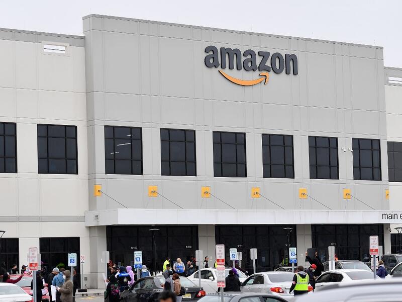 In this file photo taken on March 30, 2020, Amazon workers at Amazon's Staten Island warehouse strike in demand that the facility be shut down and cleaned after one staffer tested positive for the coronavirus in New York. (AFP/File)