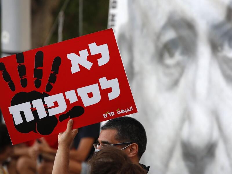 Protesters carry a placard which reads in hebrew "no to annexation" as they gather in Tel Aviv's Rabin Square on June 6, 2020. JACK GUEZ / AFP