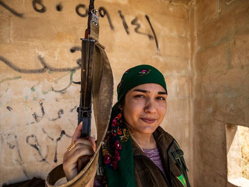 A Kurdish female volunteer, from the newly formed Community Protection Forces, guards a wheat field, against threats by jihadists to burn the crops, during harvest season on June 13, 2020, in the countryside east of Qamishli in Syria's northeastern Hasakah province. Delil SOULEIMAN / AFP