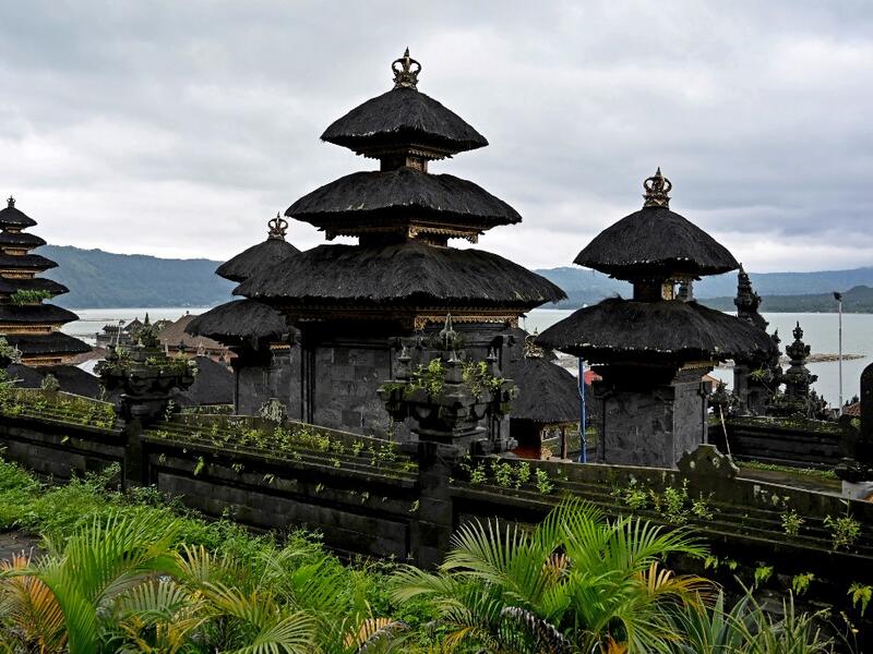 This picture taken on February 20, 2020 show a Balinese temple on the shores of Lake Batur near the village of Trunyan, home to the Trunyanese - who fuse animist beliefs and traditional village customs with their own interpretation of Hinduism - in Bangli Regency on Indonesia's Bali island. SONNY TUMBELAKA / AFP