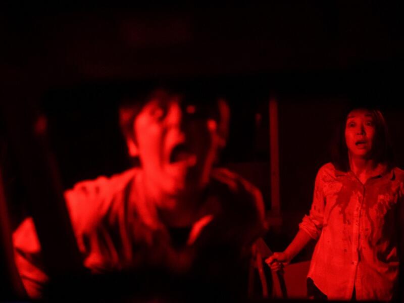 But this drive-in haunted house in Japan protects against the most terrifying enemy of all -- coronavirus. Inside a car, guests can scream as loudly as they like, with no mask required, as hideous creatures daubed in blood swarm towards them.  Philip FONG / AFP