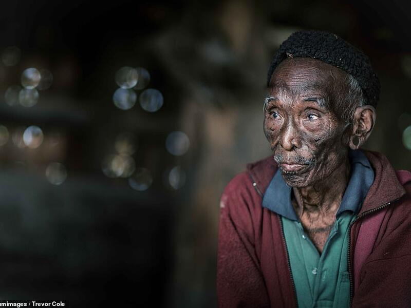 A frail-looking tribesman wears green shirt and red jacket with a black wool hat in what appears to be a merging of traditional culture with more western fashion trends. (Mediadrumimages/ Trevor Cole)