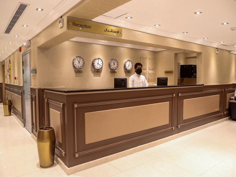 A reception staff wears a protective mask at a hotel in the holy city of Mecca on June 27, 2020. This year's hajj, which has been scaled back dramatically to include only around 1,000 Muslim pilgrims as Saudi Arabia battles a coronavirus surge, will begin on July 29, authorities said. AFP