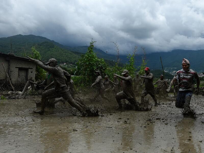 Splashing mud and drinking local rice beer, Nepali farmers this week celebrated National Paddy Day to mark the beginning of the rice-planting season, despite some coronavirus lockdown measures still in place. Traditional farming songs and laughter echoed in the air as farmers waded into waterlogged fields to sow green paddy.  PRAKASH MATHEMA / AFP