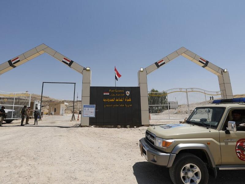 Members of the Hashed al-Shaabi (Popular Mobilisation) paramilitary forces stand guard on the Iraqi side of the Mandili crossing on the border with Iran on July 11, 2020. Iraqi Prime Minister Mustafa al-Kadhemi launched a new campaign against corruption at the country's borders, saying millions of dollars were being lost by not properly taxing imported goods. Thaier Al-SUDANI / POOL / AFP