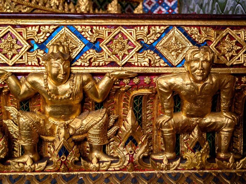 This photograph taken on July 14, 2020 shows a gold-plated sculpture of British football player David Beckham (R) in a Manchester United jersey at the base of a Buddha statue at the Wat Pariwat Buddhist temple in Bangkok. Wat Pariwat, also known as "the David Beckham Temple", is decorated with statues of superheroes and comic characters as well as mythical and imaginary creatures. A golden-plated sculpture of the English football player holding the base of a Buddha statue in one of the buildings gives the t