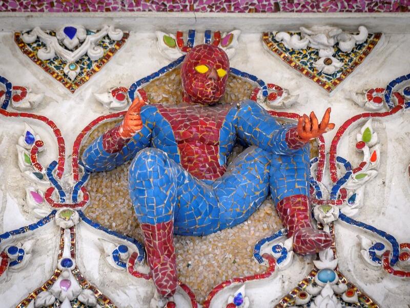 This photograph taken on July 14, 2020 shows a figure of Spiderman on the facade of the Wat Pariwat Buddhist temple in Bangkok. Wat Pariwat, also known as "the David Beckham Temple", is decorated with statues of superheroes and comic characters as well as mythical and imaginary creatures. A golden-plated sculpture of the English football player holding the base of a Buddha statue in one of the buildings gives the temple its nickname. Mladen ANTONOV / AFP