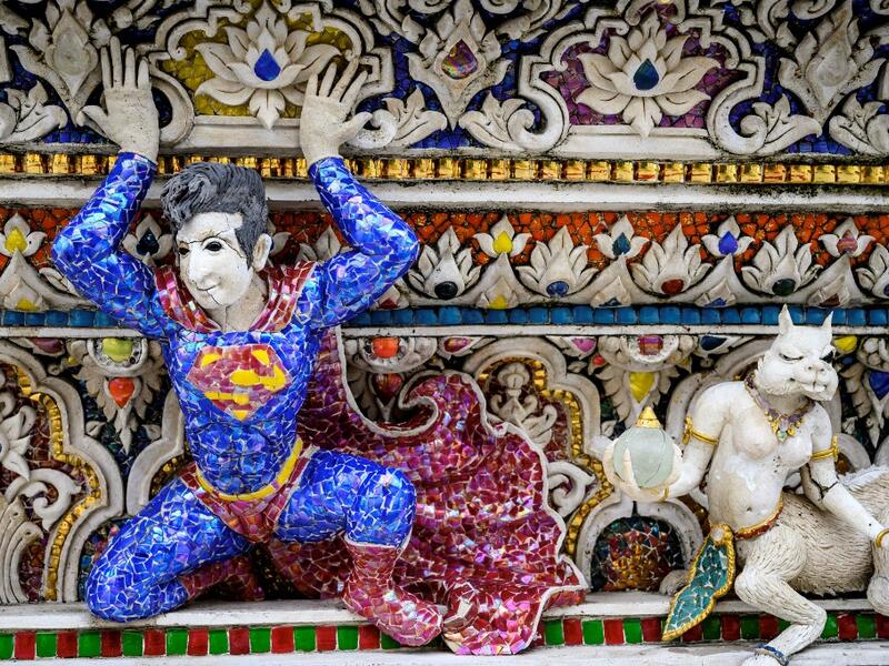 This photograph taken on July 14, 2020 shows a figure of Superman on the facade of the Wat Pariwat Buddhist temple in Bangkok. Wat Pariwat, also known as "the David Beckham Temple", is decorated with statues of superheroes and comic characters as well as mythical and imaginary creatures. A golden-plated sculpture of the English football player holding the base of a Buddha statue in one of the buildings gives the temple its nickname. Mladen ANTONOV / AFP