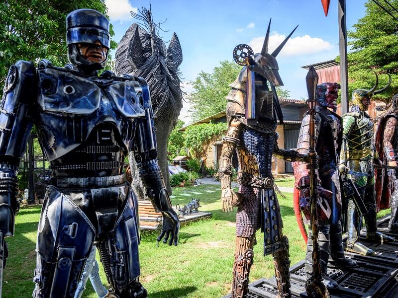 This photograph taken on July 18, 2020 shows a life-sized sculpture of Robocop and other figures made of scrap metal parts at the Ban Hun Lek museum in Ang Thong, some 100km north of Bangkok. "Ban Hun Lek" or "The House of Steel Robots" is a museum where a collective of artists display their scrap metal creations depicting popular comics and sci-fi film characters. Mladen ANTONOV / AFP
