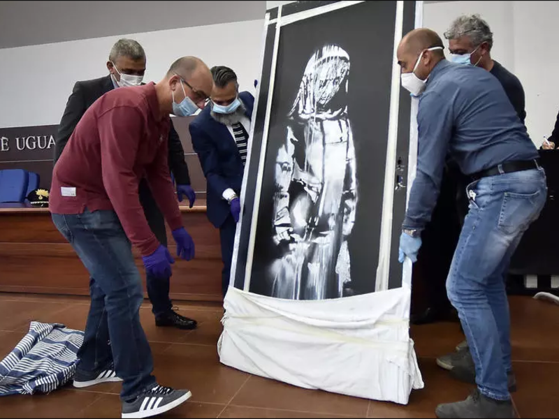 An artwork attributed to Banksy stolen from the Bataclan in Paris in 2019 was found in an abandoned Italian farmhouse. (AFP/File)