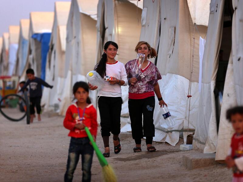 Displaced Iraqis from the Yazidi community, who fled violence between Islamic State (IS) group jihadists and Peshmerga fighters in the northern Iraqi town of Sinjar, are seen at a camp for internally displaced persons (IDP) in the Sharya area some 15 kilometres from the northern Iraqi city of Dohuk on May 20, 2015. (AFP / Safin Hamed)