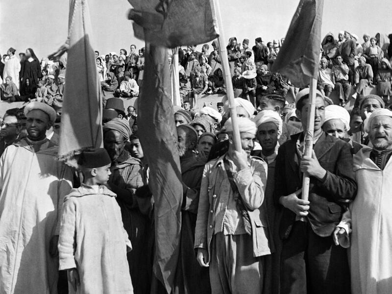 People hold Moroccan flags during a ceremony on the Grand Socco place, in October 1945 in Tangiers, Morocco. AFP