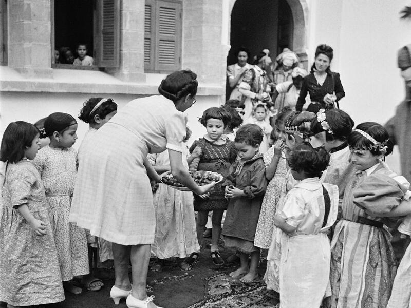 A teacher gives cakes to schoolgirls, in October 1945, in a school in Rabat, Morocco. AFP