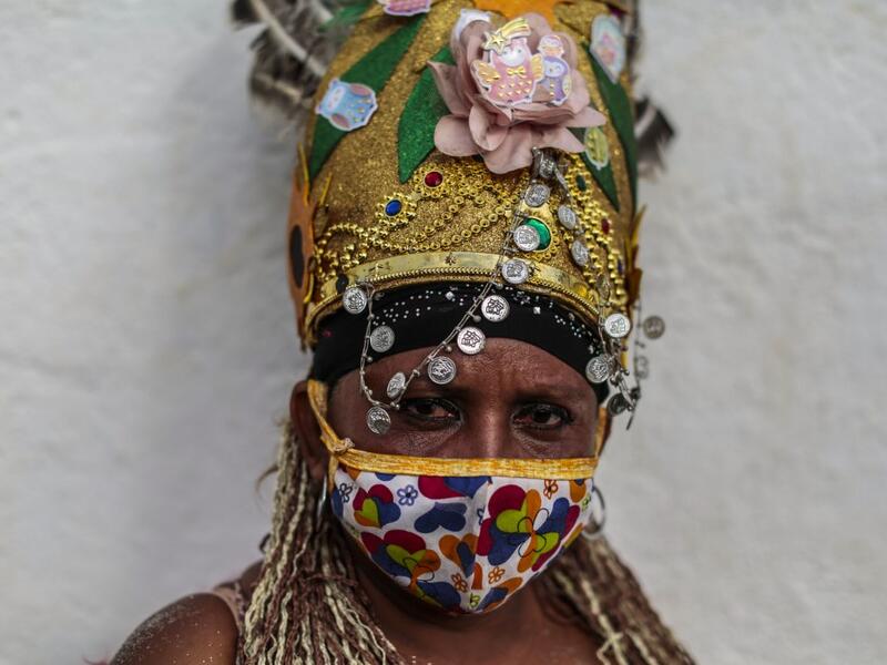 A Catholic faithful poses for a picture as she takes part in the opening of the ten-day celebration of the Santo Domingo de Guzman festival, outside the Las Sierritas de Santo Domingo church in Managua, on August 1, 2020 amid the COVID-19 novel coronavirus pandemic. Despite the Catholic Church cancelling all religious activities due to the coronavirus pandemic, devotees gathered outside the church for the celebration. Inti OCON / AFP