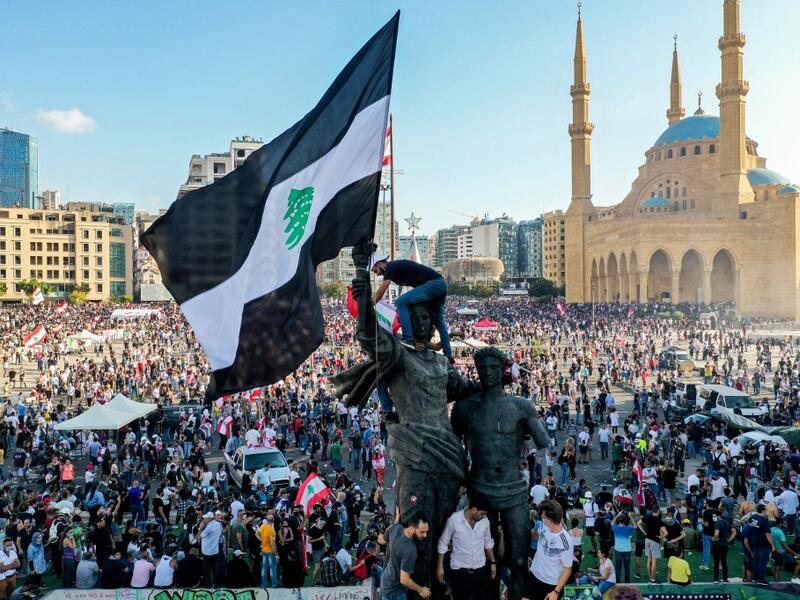 This picture taken on August 8, 2020 shows an aerial view of the demonstration in downtown Beirut against a political leadership they blame for a monster explosion that killed more than 150 people and disfigured the capital Beirut. AFP