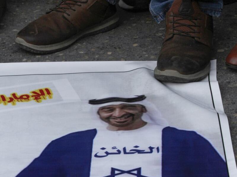 Palestinian refugees tread on a picture of Abu Dhabi Crown Prince Sheikh Mohammed bin Zayed Al Nahyan, during a demonstration against the Emirati-Israeli agreement in the Lebanese southern coastal city of Tyre, on August 15, 2020. Mahmoud ZAYYAT / AFP