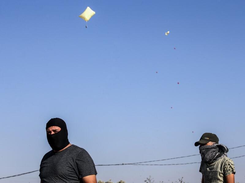 Inflated plastic bags carrying incendiary devices float in the air upon being released by Palestinians and flown towards Israel, near Rafah along the border between the Gaza Strip and Israel on August 21, 2020. SAID KHATIB / AFP