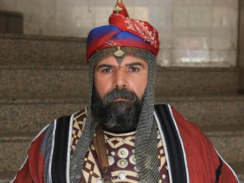 An Ashura re-enactor poses for a picture while dressed in costume as Shiite Muslims prepare to re-enact events of Ashura in the central Iraqi holy shrine city of Karbala on August 22, 2020. Ashura is a period of mourning in remembrance of the seventh-century martyrdom of Prophet Mohammad's grandson Imam Hussein, who was killed in the battle of Karbala in modern-day Iraq, in 680 AD. Mohammed SAWAF / AFP